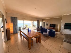 a living room with a couch and a table at On The Hill in Stompneusbaai