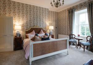 a bedroom with a bed and a table and chairs at College Hill House in Slane