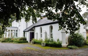 a white house with a black roof at College Hill House in Slane