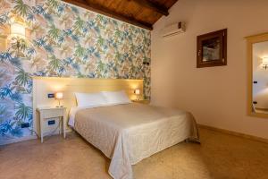 a bedroom with a bed and a floral wall at Duomo Apartments Affittacamere in Cefalù