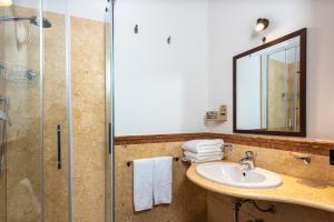 a bathroom with a sink and a shower at Duomo Apartments Affittacamere in Cefalù