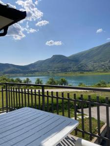 a bench on a balcony with a view of a lake at Apartmani Mia in Prozor