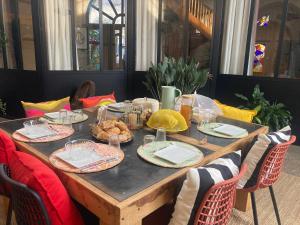 a wooden table with plates of food on it at La Rotonde in Poligny