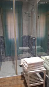 a bathroom with a shower and a pile of towels at La Vivienda de Morales in Morales del Vino +12 photos