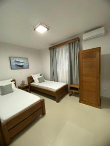 a hotel room with two beds and a window at Hasoa Villa in Morondava