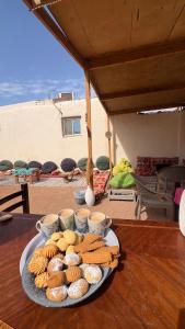 a plate of food on a wooden table at SafeZone Guesthouse in Dahab +27 photos