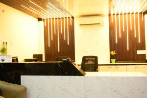 an office with a desk and chairs in a room at Hotel O Westin Regency in Monber