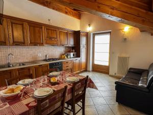 a kitchen with a table with food on it at Appartamento Pommier 2 in Saint-Pierre +16 photos