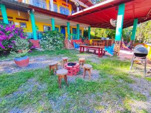 a group of stools in a yard with a playground at Las Catalinas Ecológicas (El Maizal) in Antón