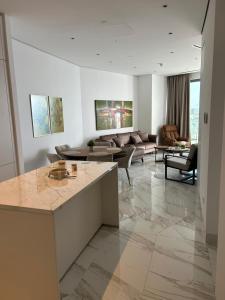 a living room with a couch and a table at Trilogy Limassol East Tower Seafront Apartment in Limassol