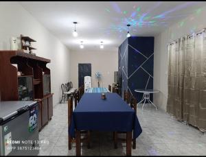 a dining room with a blue table and chairs at Los Horneros Zamba in Cerrillos