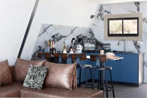 a living room with a bar with a couch at Peace Haven @ Windfarm Accommodation in Yzerfontein