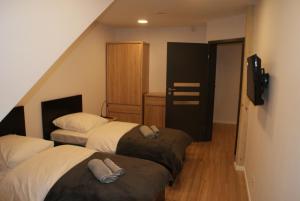 two beds in a room with a staircase at Kwiatowe Zacisze in Szczyrk +102 photos