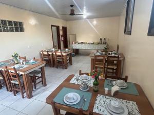 a dining room with wooden tables and chairs at Golden Hotel Ltda - Próximo a DPM, Aeroporto, Rodoviaria Porto Alegre, Arena do Grêmio in Porto Alegre