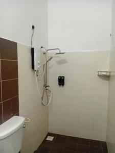 a bathroom with a shower with a toilet at KTL Homestay in Kuantan +6 photos