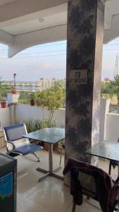 a patio with two tables and a no smoking sign at Green male rooms in Bhopal