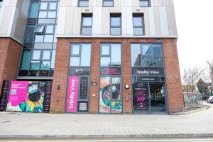 a brick building with signs on the front of it at Studios For 2 Near Coventry Station in Coventry