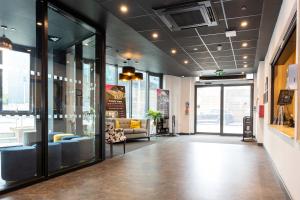 a lobby with couches and chairs in a building at Studios For 2 Near Coventry Station in Coventry +10 photos
