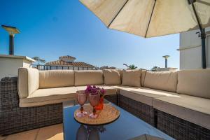 a patio with a couch and two glasses on a table at Spacious Villa - DN32LT in Torre-Pacheco