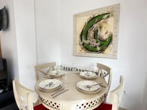 a dining room table with chairs and a painting on the wall at Spacious Villa - DN32LT in Torre-Pacheco