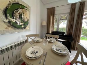 a dining room table with plates and wine glasses at Spacious Villa - DN32LT in Torre-Pacheco