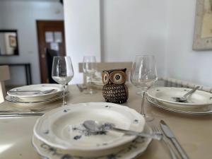 an owl ornament sitting on a table with plates and glasses at Spacious Villa - DN32LT in Torre-Pacheco +49 photos