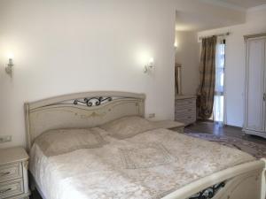 a bedroom with a large bed with a white comforter at Deer Villa in Tsaghkadzor