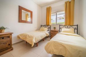 a bedroom with two beds and a mirror and a window at Villa with Private Pool - LO4LT in Torre-Pacheco +78 photos