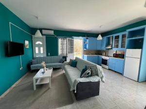 a blue living room with a couch and a table at Bella's House in Theologos