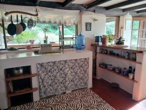a kitchen with a sink and a counter top at The Witch's Cottage in Urubamba +14 photos