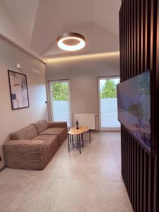 a living room with a couch and a table at Apartament 59 Bystra Park in Bystra