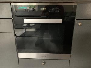 a microwave oven with a glass door in a kitchen at Appartement in Bad Kreuznach +8 photos