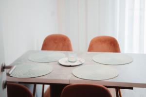 a table with four chairs with plates and a candle on it at Haus Edelweiss in Tarrenz