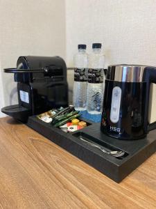 a coffee maker and a toaster and bottles of water at Grand Christer Hotel in Kyiv