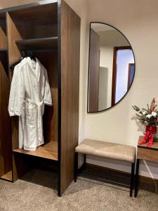 a dressing room with a mirror and a white shirt at Grand Christer Hotel in Kyiv +55 photos
