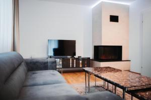 a living room with a couch and a tv at Haus Edelweiss in Tarrenz