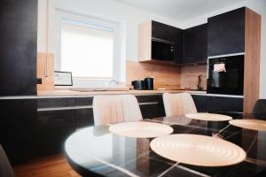 a kitchen with a glass table with chairs and a counter at Haus Edelweiss in Tarrenz