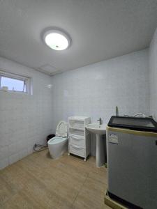 a bathroom with a toilet and a sink at Townhome 44 in Ban Nong Pru