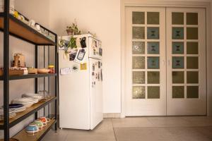 a kitchen with a white refrigerator in a room at VAARAK in Bosa