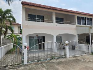 a white house with a gate in front of it at Townhome 44 in Ban Nong Pru
