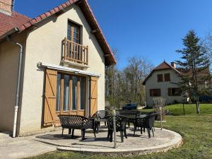 a group of chairs and tables in front of a building at Escapade in Soulaines-Dhuys