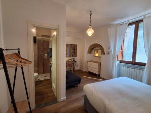 a bedroom with a bed and a room with a bathroom at Civico 10 in Gubbio