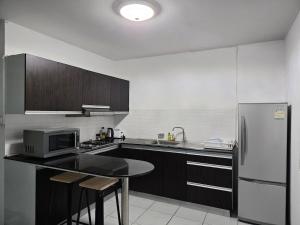 a kitchen with a refrigerator and a table in it at Townhome 44 in Ban Nong Pru +8 photos