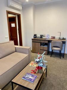 a living room with a couch and a table at Grand Christer Hotel in Kyiv