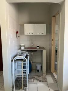 a small kitchen with a sink and a counter at Estação 48 in Castanhal
