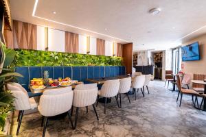 a dining room with a table and chairs at Mattis Hotel in Tirana