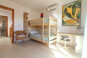 a bedroom with a bunk bed and a desk at Niteo House in Costa Teguise +19 photos