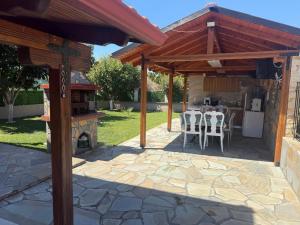 a pavilion with a table and chairs on a patio at Nadya Holiday Home in Karianí