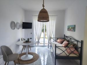 a living room with a table and a couch at Villa Rizia in Kolymbia