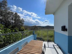 a balcony of a house with a wooden walkway at Bella's House in Theologos